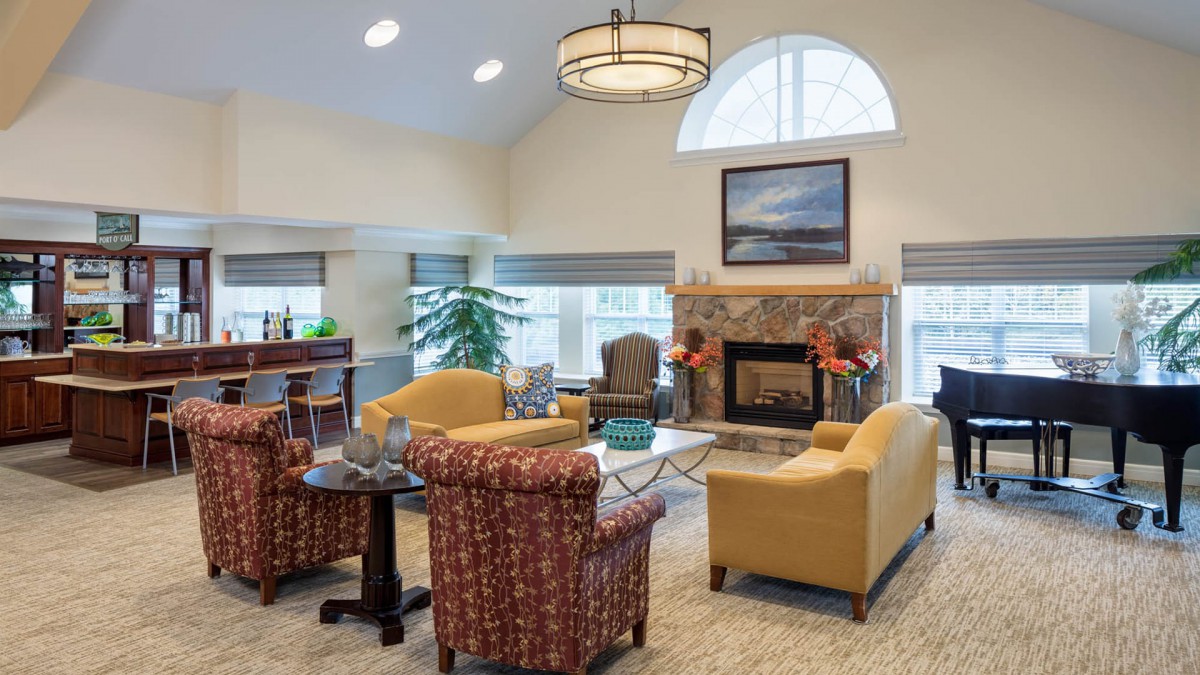 A cozy living room with comfortable seating around a fireplace.
