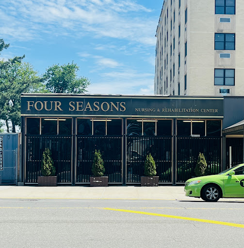 The Four Seasons restaurant showcasing its welcoming facade amidst a lively urban setting.