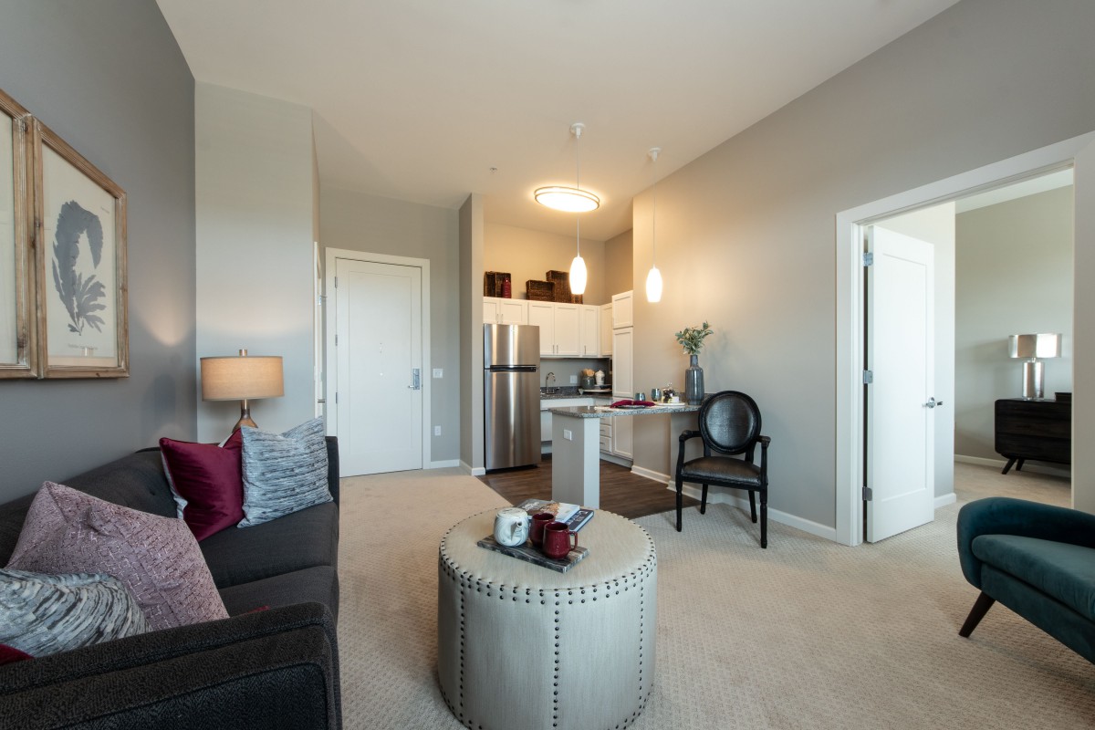 A modern apartment with an open concept living room and kitchen.