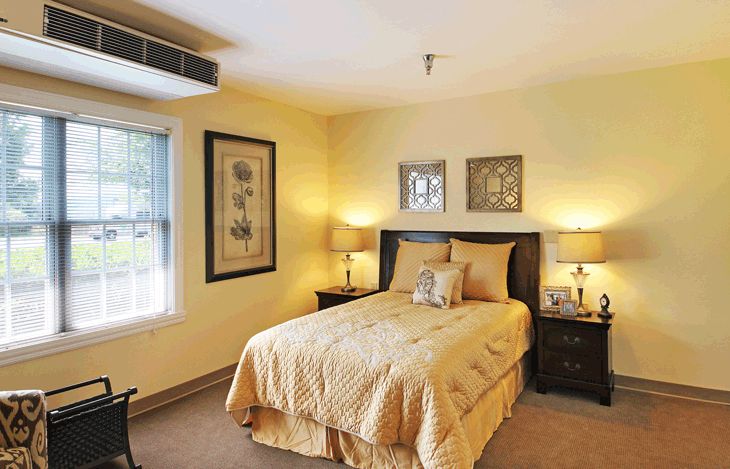 A cozy bedroom with elegant decor and warm lighting.
