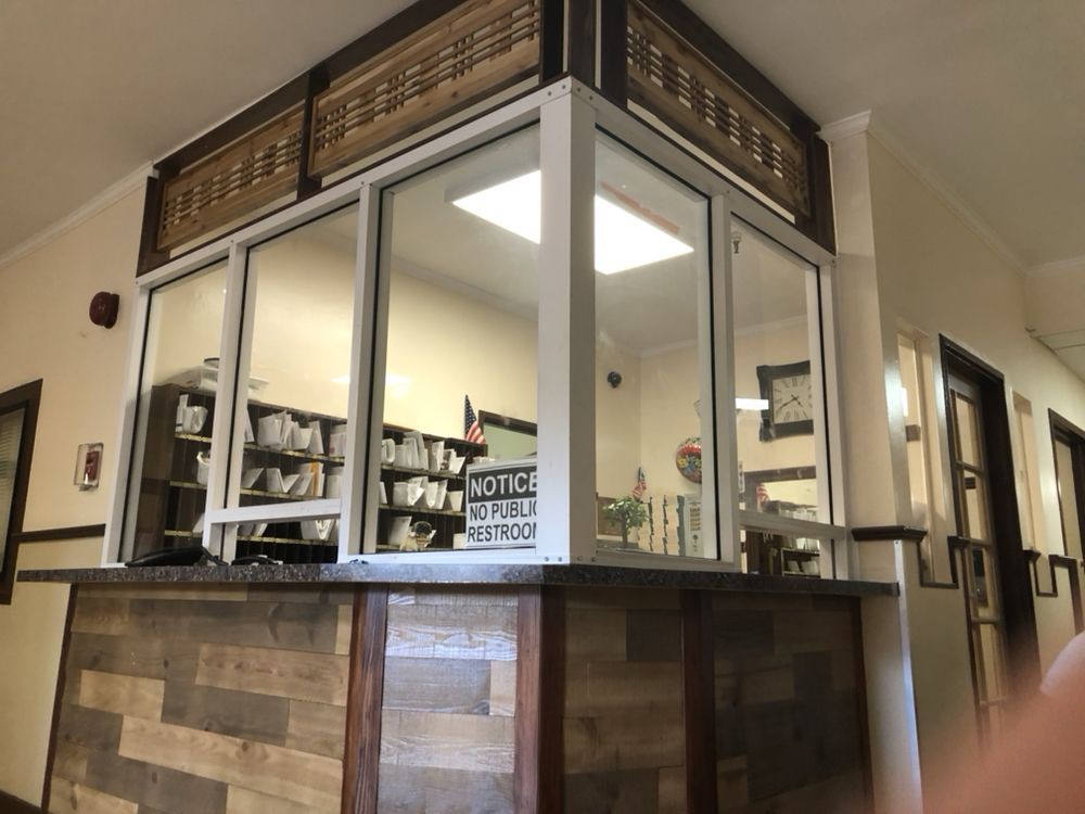 A reception area with a wooden counter and glass windows.