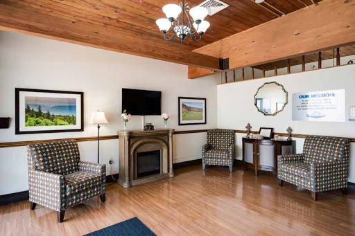 A cozy living room featuring a fireplace, stylish seating, and modern decor.