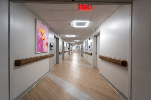 A well-lit and modern hospital hallway adorned with colorful artwork.