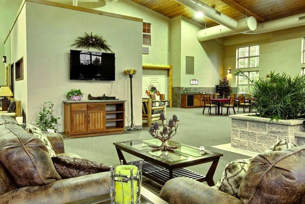 A spacious living room with comfortable seating, wooden ceiling, and tasteful decor.