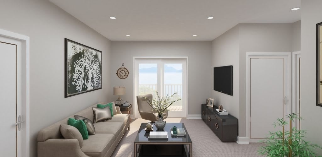 A modern living room featuring a comfortable sofa, stylish decor, and a wall-mounted TV.