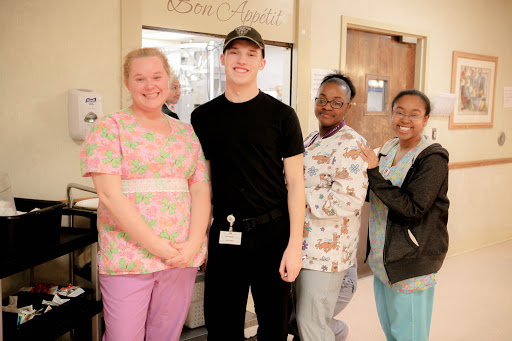 A group of medical staff members posing together in a hospital setting, showcasing teamwork and camaraderie.