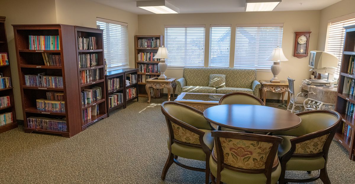 A cozy reading room with bookshelves and comfortable seating.