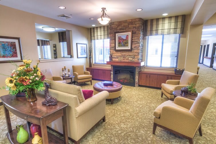 A cozy living room with a fireplace, comfortable seating, and warm decor.