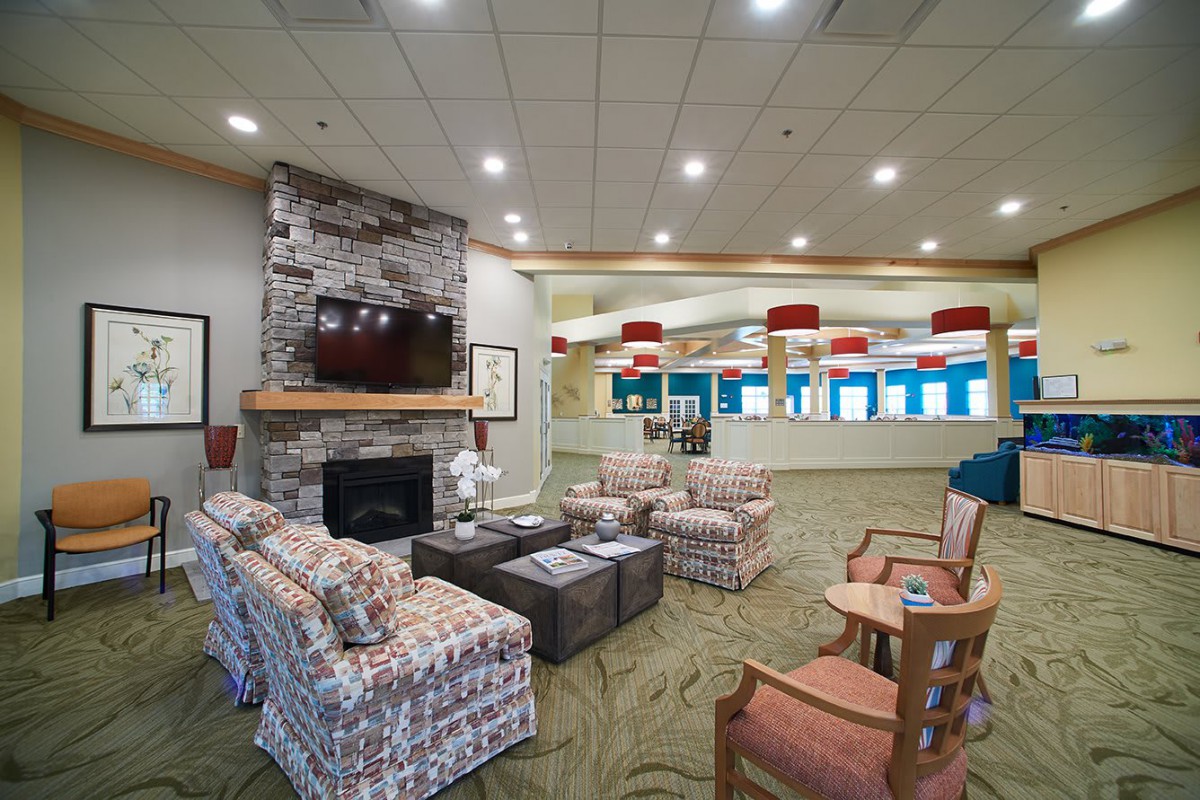 A cozy living room interior featuring a fireplace, television, and comfortable seating area.