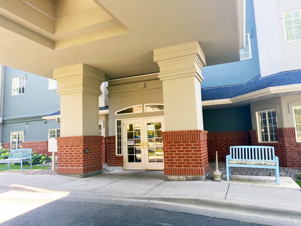 Entrance to a building with brick and column architecture.