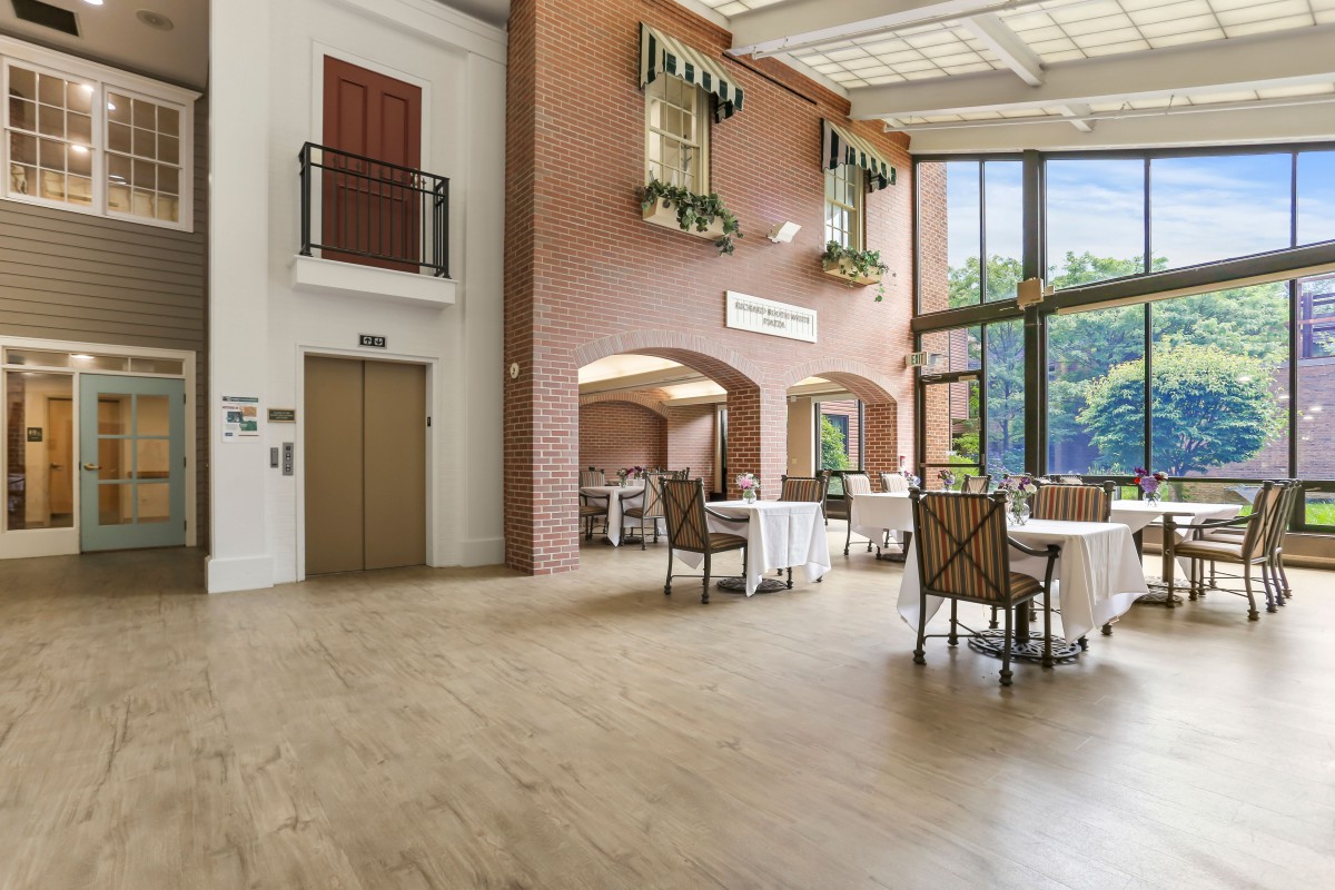 A spacious and modern dining area with large windows allowing natural light to fill the room.