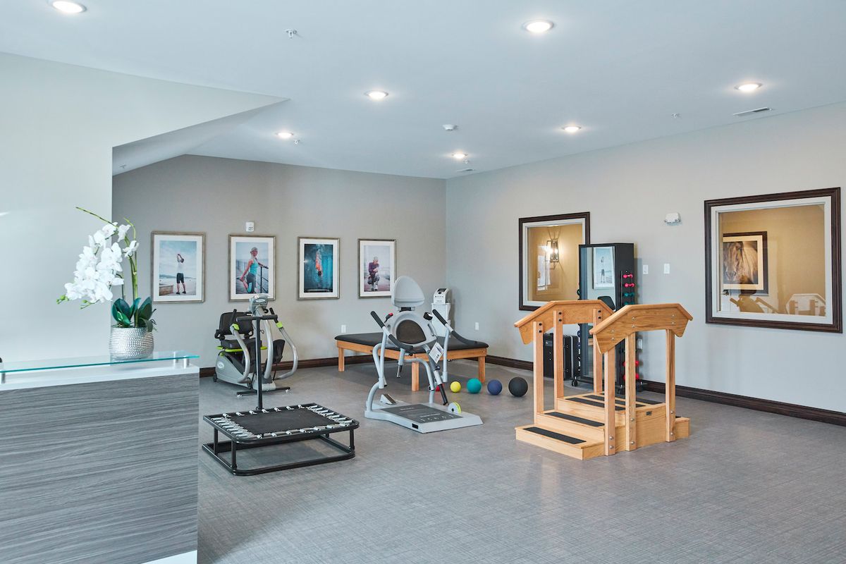 A modern fitness center featuring a variety of exercise equipment.