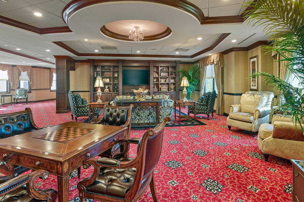 A luxurious library and living room area with opulent furnishings and decor.