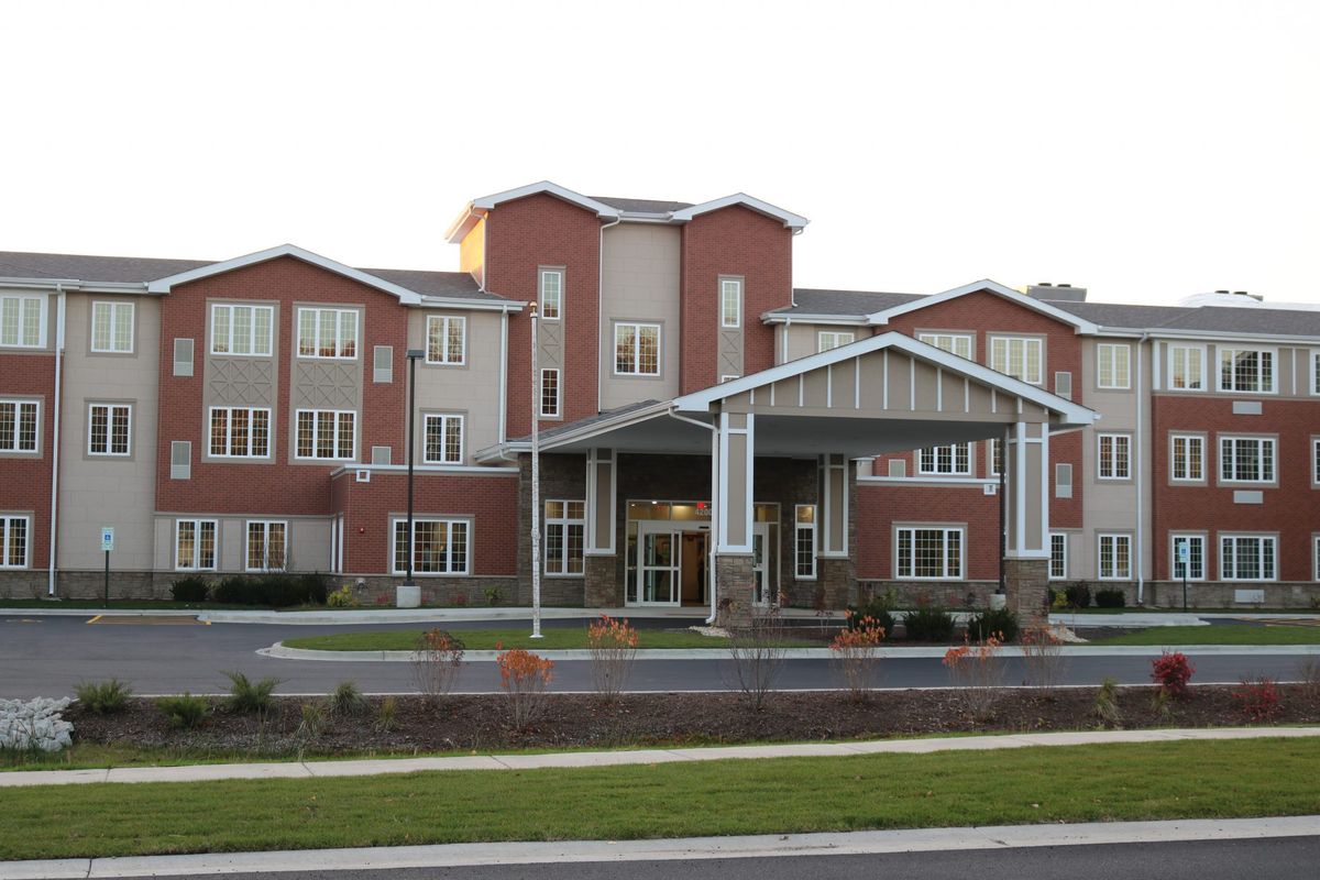 A modern healthcare facility with a brick exterior and large windows.
