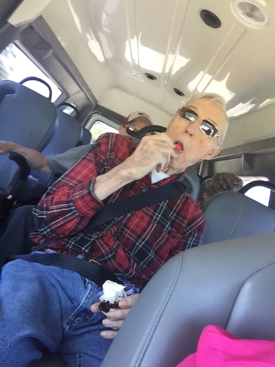 A passenger enjoying a snack on a bus ride.