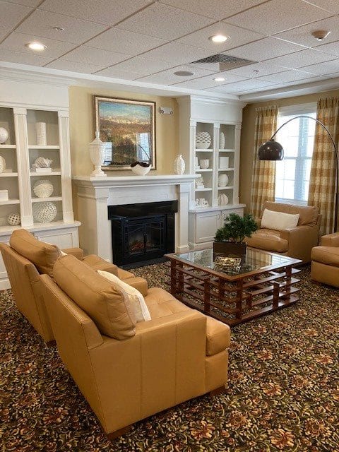 A cozy living room with warm tones, featuring a fireplace and elegant decor.
