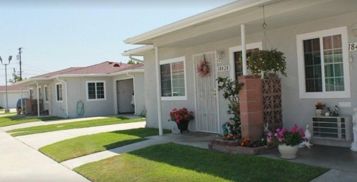 A peaceful residential home with a well-maintained front yard and flower pots.