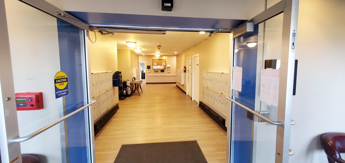 A building lobby with mailboxes and a reception area.