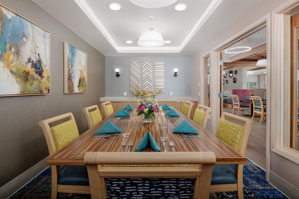 A beautifully decorated dining room with a large table and colorful accents.