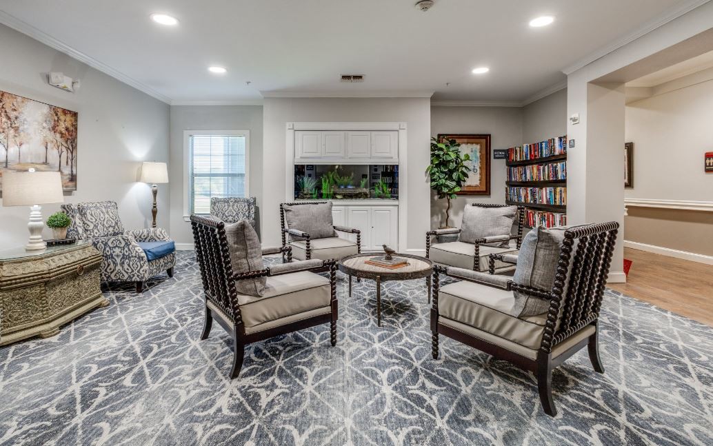 A modern living room with comfortable seating, a bookshelf, and tasteful decor.