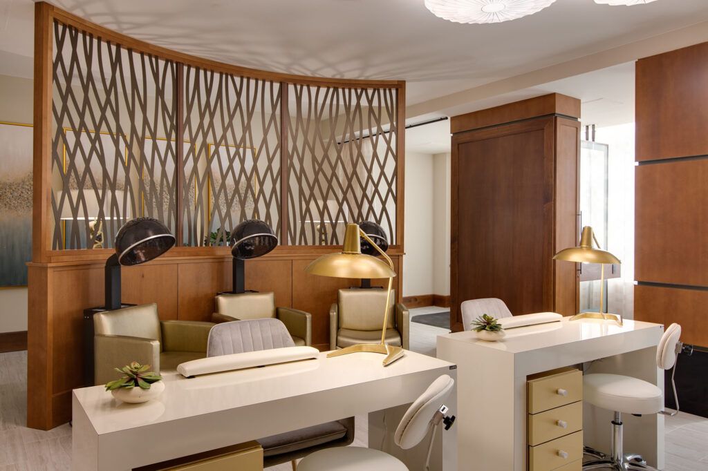 A modern and luxurious salon interior with elegant furnishings and warm lighting.
