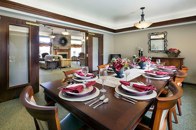 A beautifully set dining room table with elegant decor and ambient lighting.