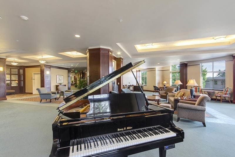 A luxurious lobby featuring a grand piano and elegant seating arrangements.