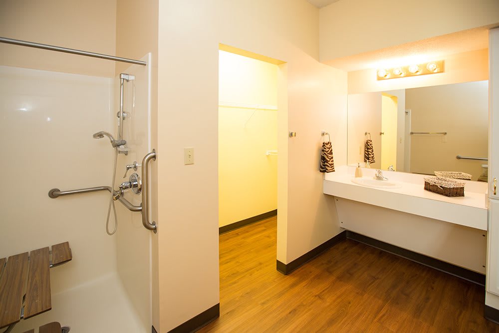 A modern bathroom with a spacious shower and a large sink area.