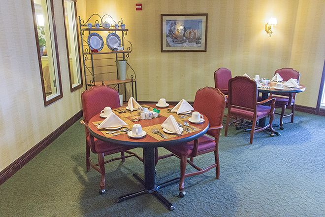 A neatly set dining table in a restaurant with elegant decor.