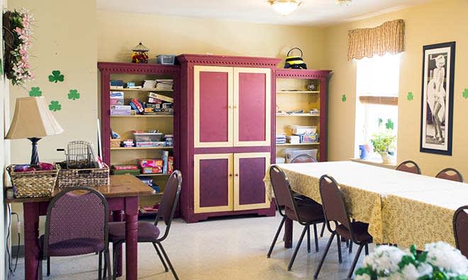 A well-organized study room with bookshelves, tables, and chairs.