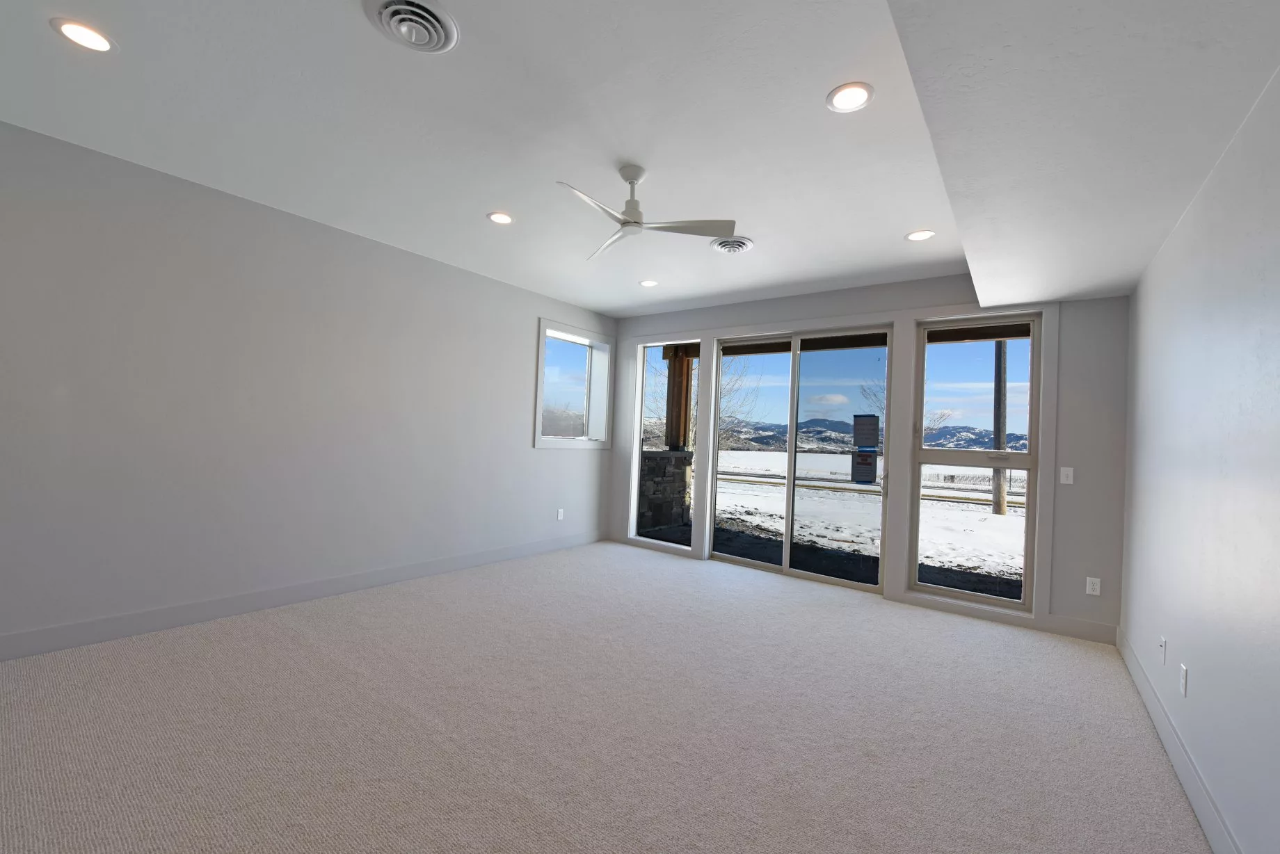 A spacious and modern living room with large windows providing abundant natural light.