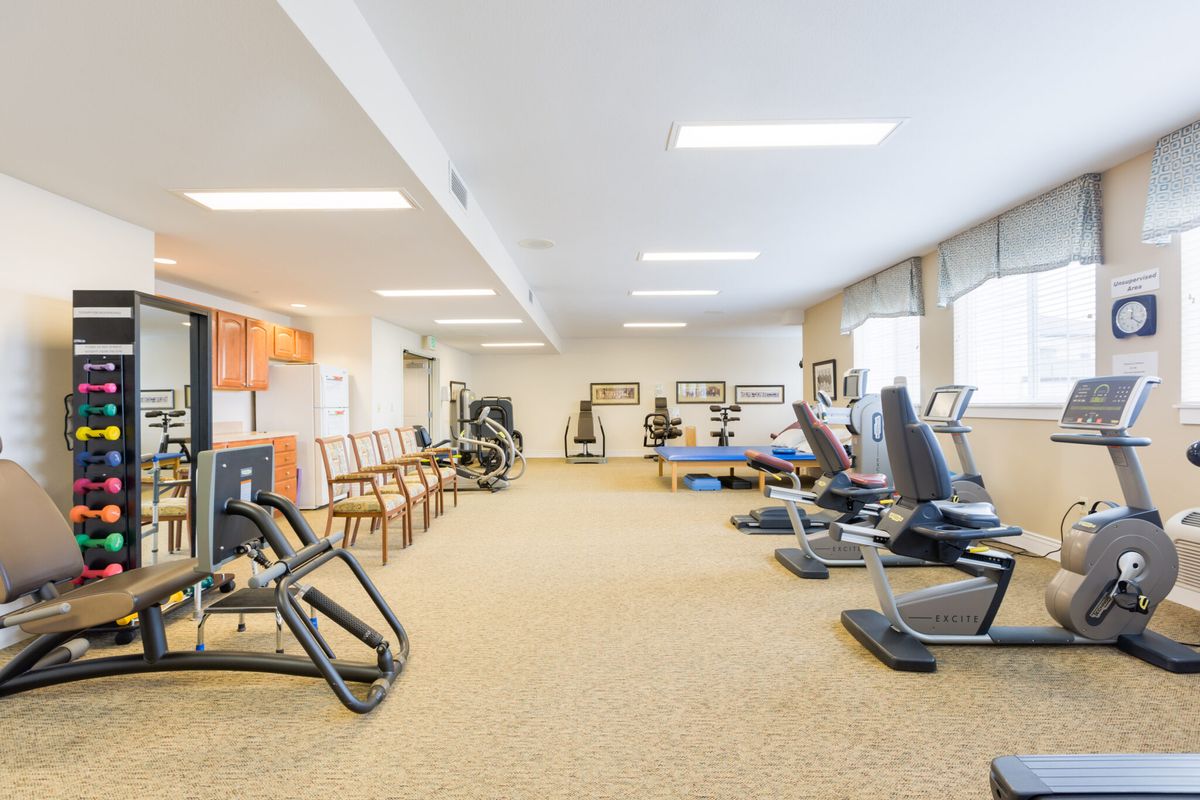 A well-equipped gym with various exercise machines and ample space.