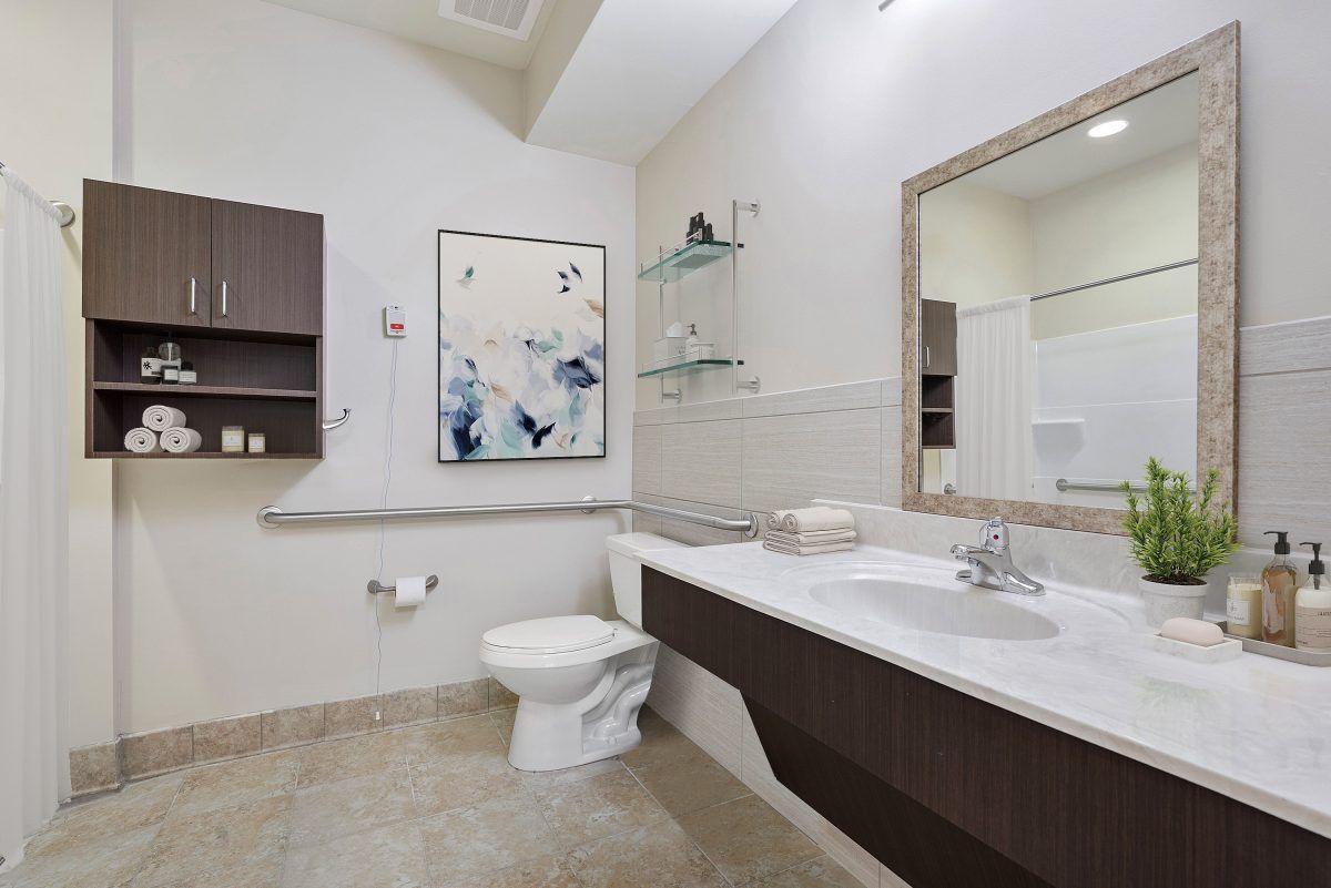 A modern bathroom with sleek fixtures and contemporary artwork.