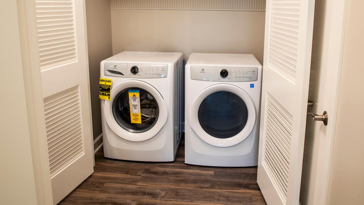 A set of front-loading washer and dryer in a laundry room.
