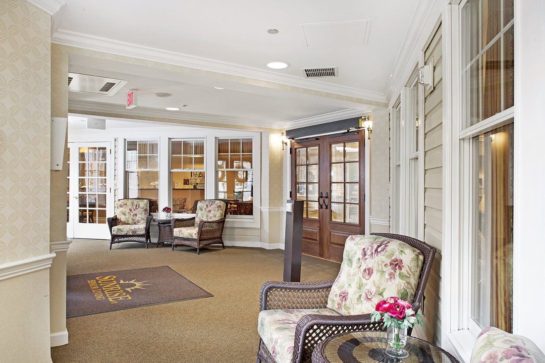 A welcoming lobby area with comfortable seating, decorative flowers, and natural lighting.