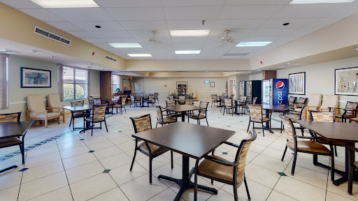 An empty dining area featuring tables and chairs, ready for patrons.