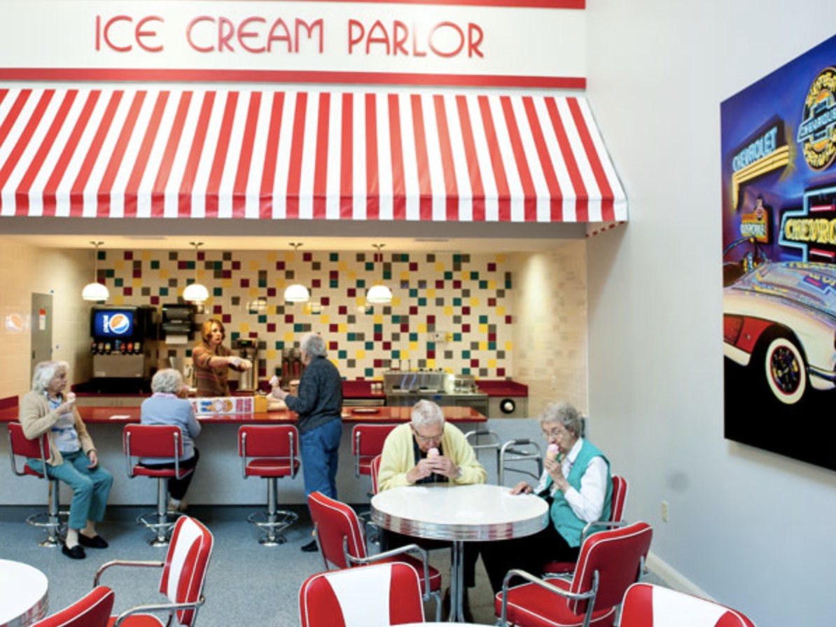A retro-style ice cream parlor with a red and white theme, featuring patrons enjoying their time.