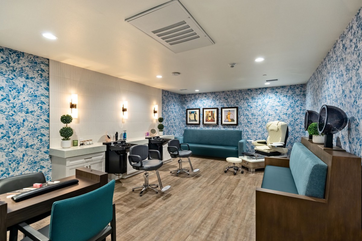 A modern beauty salon with stylish seating and elegant decor.