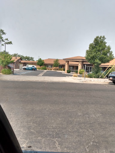 A view of a residential area with houses and parked cars.