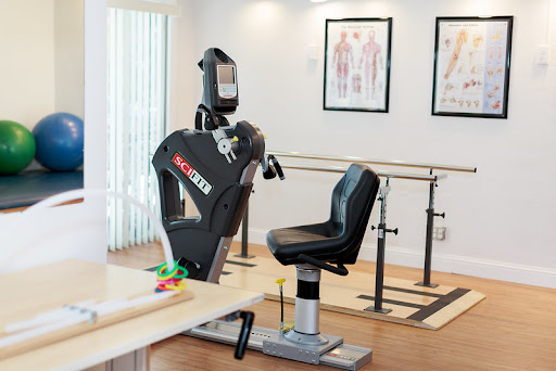 A modern rehabilitation room featuring exercise equipment designed for physical therapy, highlighting a focus on fitness and recovery.