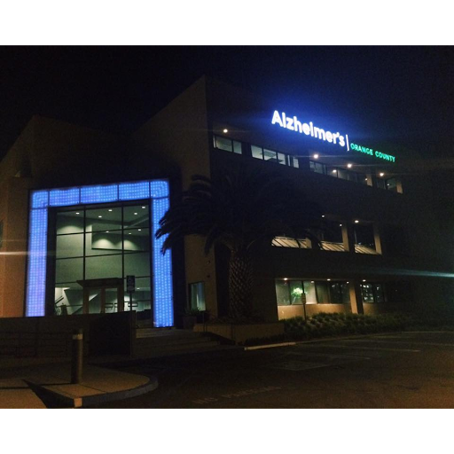 A modern office building illuminated at night.