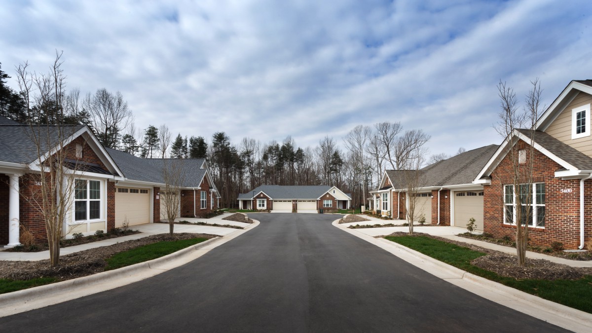 A suburban neighborhood with single-story houses along a quiet street.