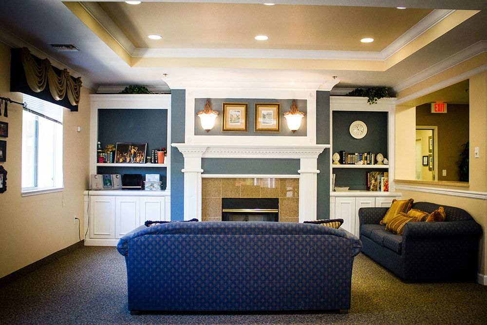 Cozy living room setup with a central fireplace and comfortable seating.