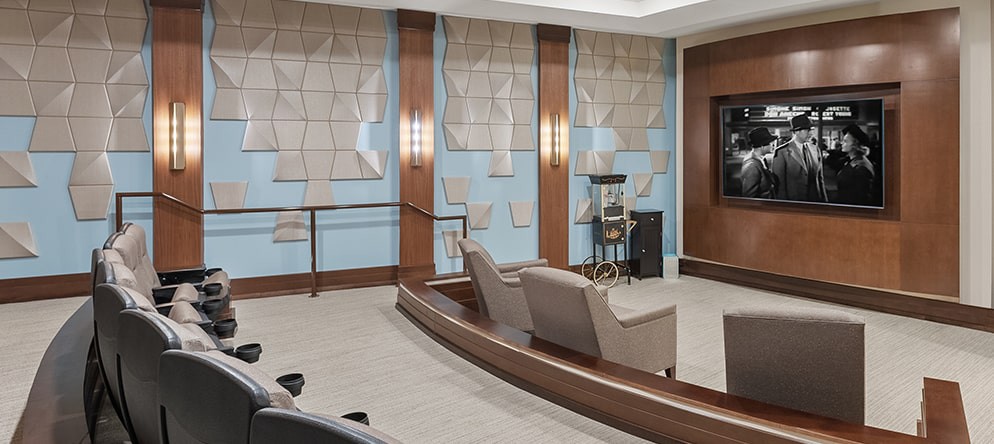 A modern conference room with stylish chairs and a world map design on the walls.
