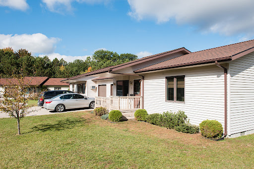 A charming single-story house with a well-maintained front yard and parked car.