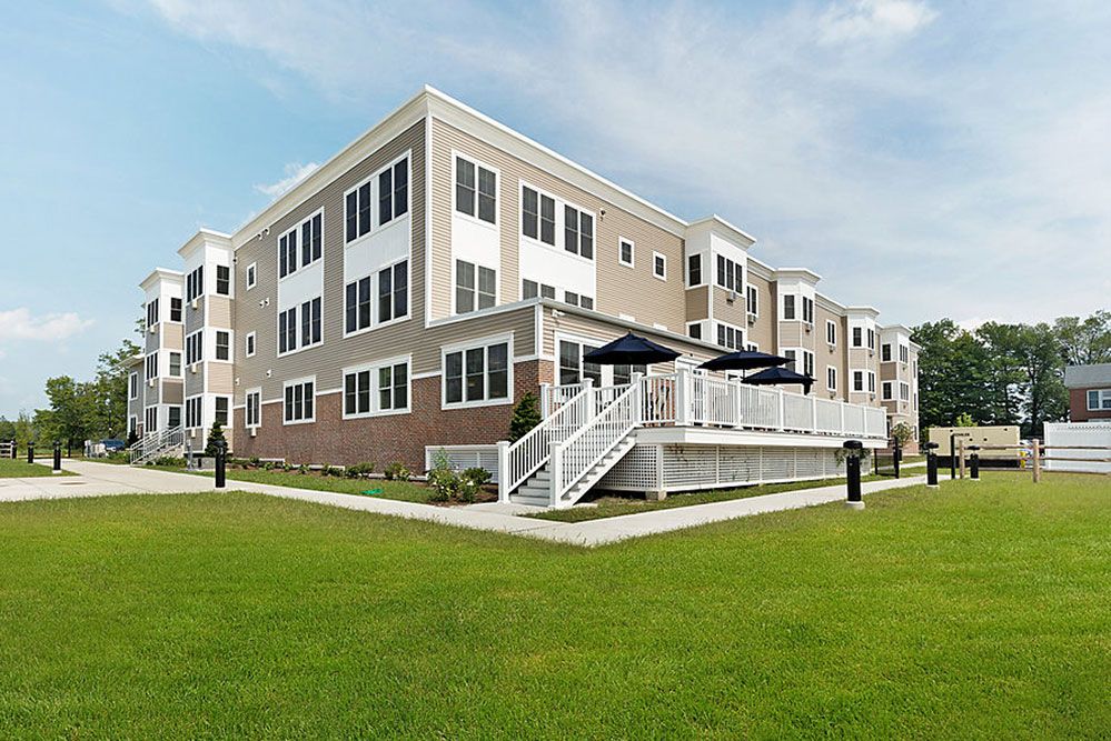 A modern residential apartment complex with well-maintained landscaping.