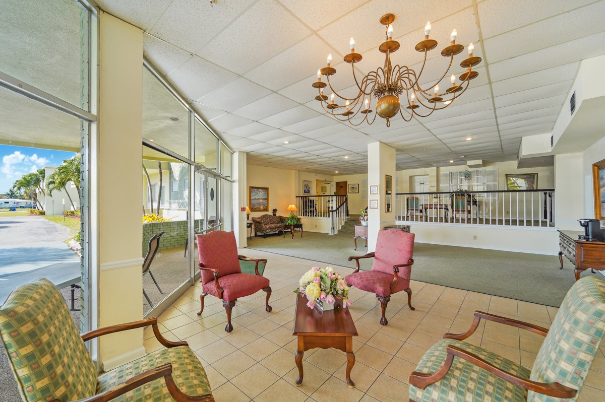 A cozy lobby area featuring elegant furniture and a large chandelier.