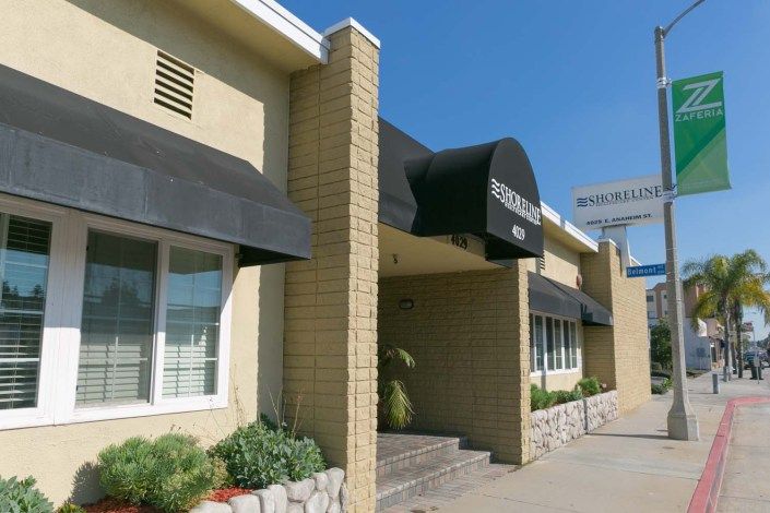 Entrance of a commercial building with awnings and signage.