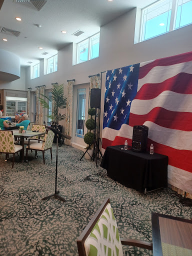 A cozy indoor venue featuring an American flag backdrop, ready for an event.
