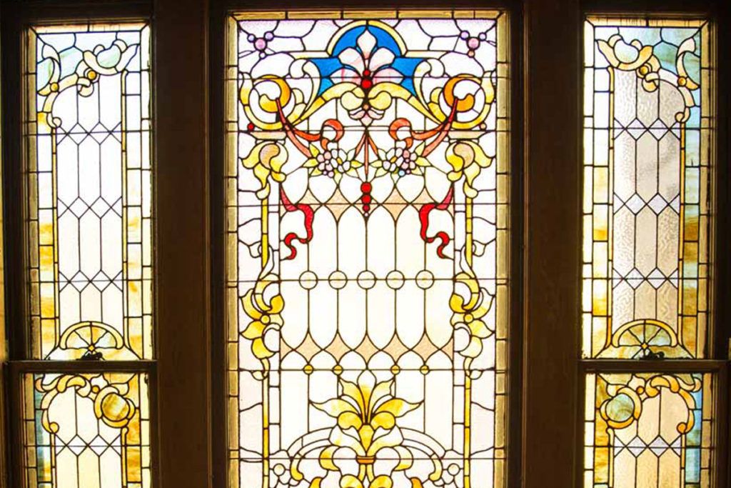 A colorful and ornate stained glass window featuring intricate designs and patterns.